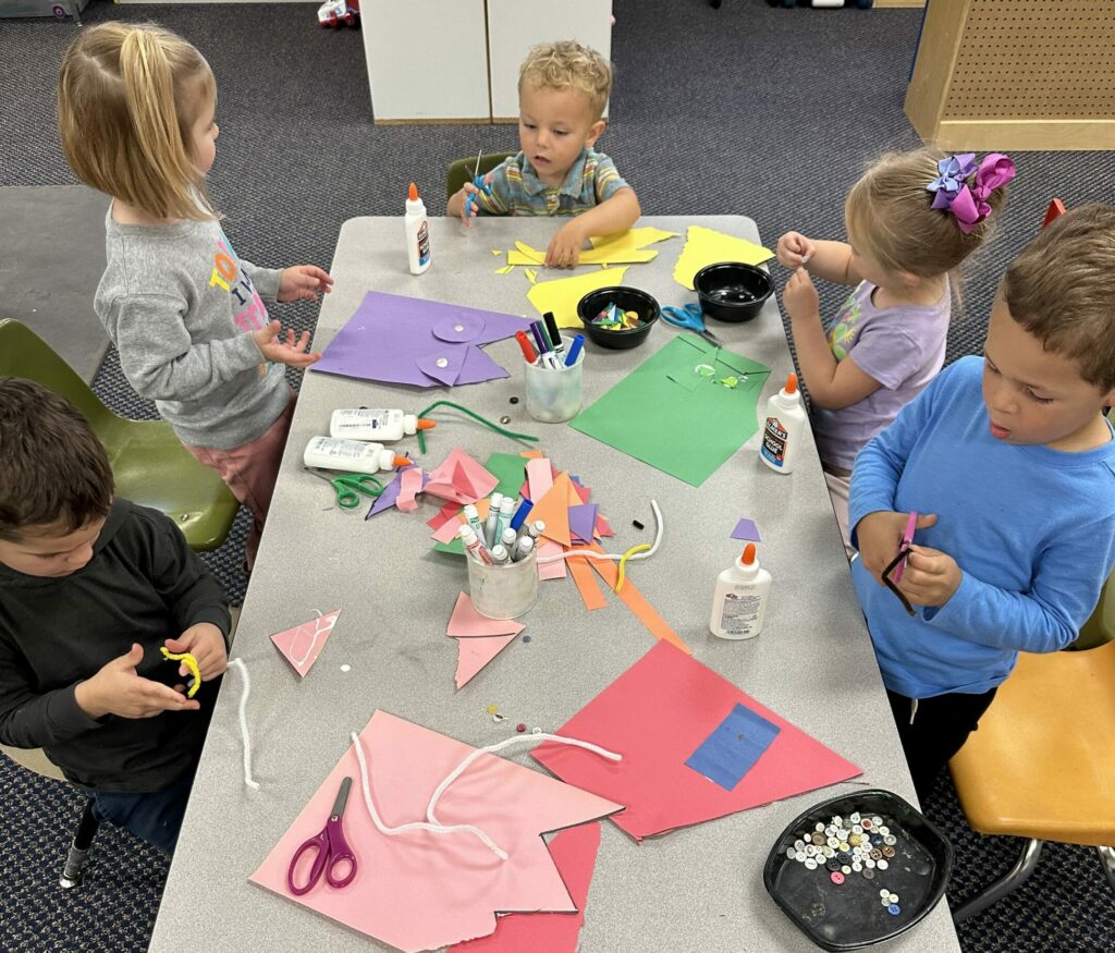 children doing creative play at a table